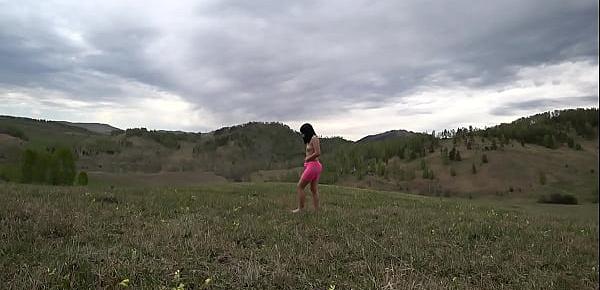  Nudist with natural hairy pussy and big ass runs in the meadow. Fusion with nature in the outdoors.